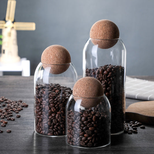 BeanVault airtight clear glass coffee storage jar filled with whole roasted coffee beans
