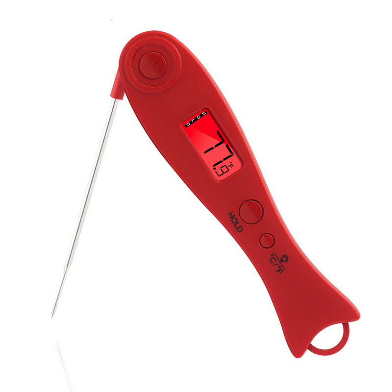 Red TempCore instant-read digital food thermometer measuring temperature inside grilled meat