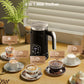 VelvetFoam electric milk frother pitchering rich creamy foam into a warm cup of coffee